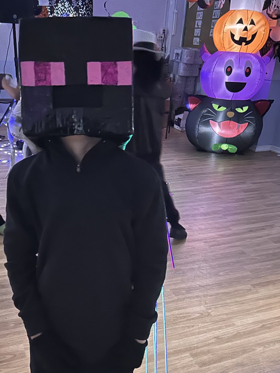 A child in a black Minecraft Enderman box-head costume